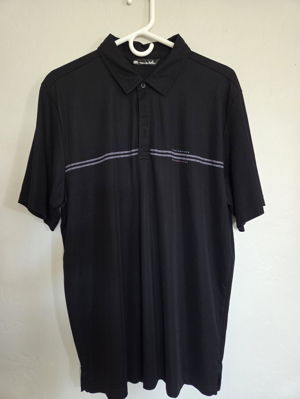 TravisMathew Black Polo with Thin Chest Stripe